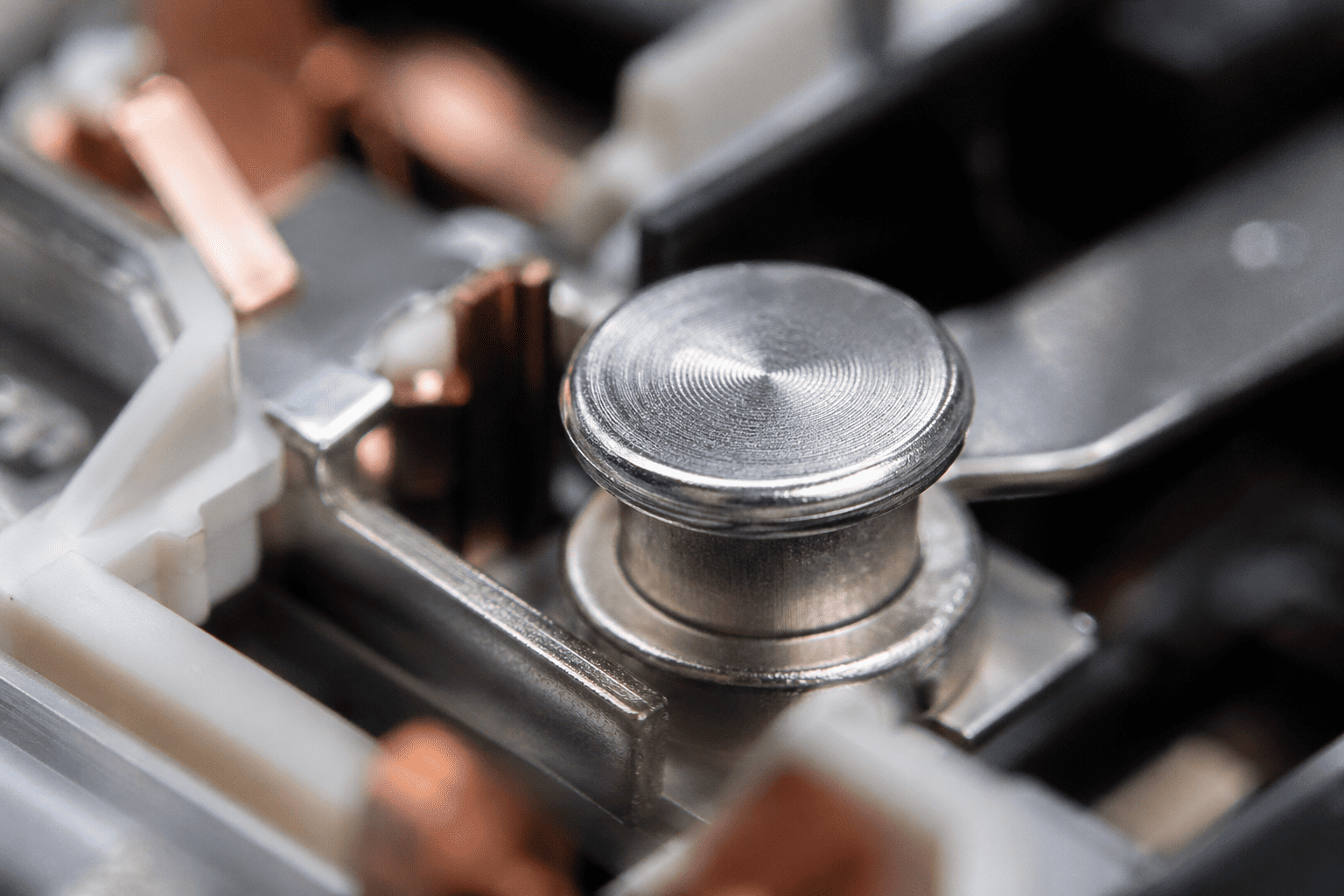 A macro photograph showing the silver contact point on a switch's internal mechanism